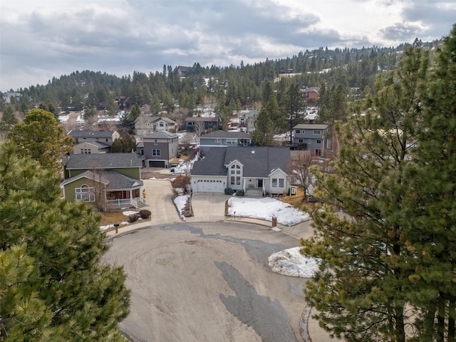 birds eye view of property with a forest view