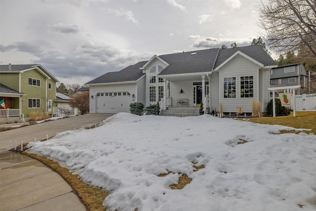 view of front facade featuring covered porch, driveway, and a garage