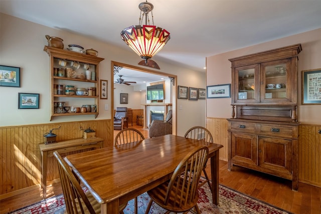 845 S California St, Helena, MT 59601 - dining space with wainscoting, wood finished floors, a ceiling fan, and wooden walls