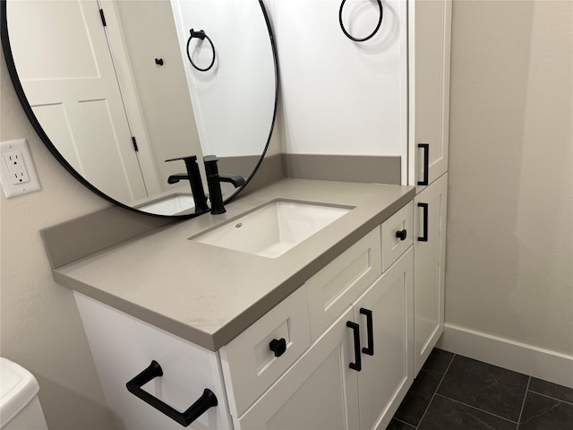 half bathroom with tile patterned flooring, toilet, vanity, and baseboards