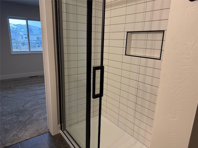 bathroom featuring tile patterned floors and a stall shower