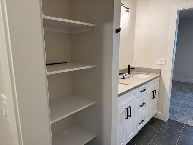 bathroom featuring double vanity, tile patterned floors, and a sink