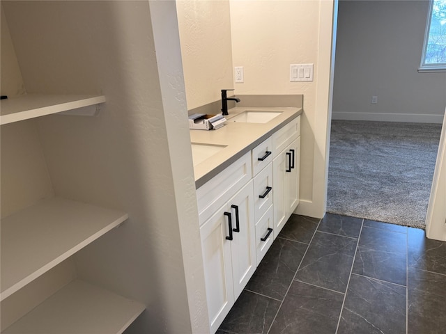 bathroom with a sink and double vanity