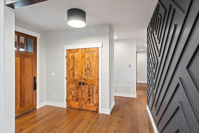 foyer with hardwood / wood-style floors, recessed lighting, baseboards, and visible vents