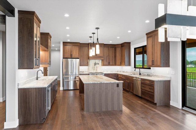 kitchen featuring dark wood-style floors, light stone countertops, a kitchen island, recessed lighting, and stainless steel appliances