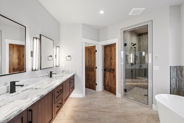 bathroom with a shower stall, a freestanding tub, visible vents, and a sink