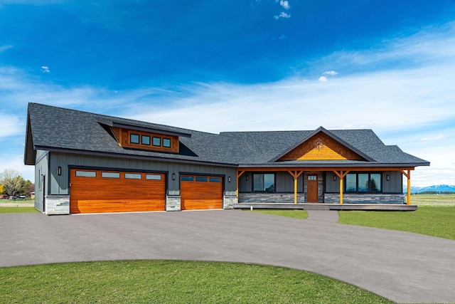 view of front of home featuring a garage, board and batten siding, driveway, and a shingled roof