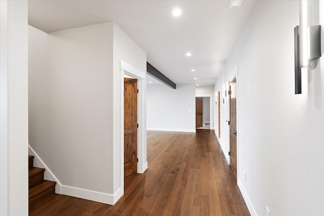 corridor featuring recessed lighting, stairs, baseboards, and dark wood-style flooring