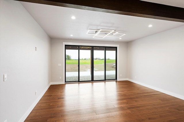 empty room with recessed lighting, baseboards, and wood finished floors