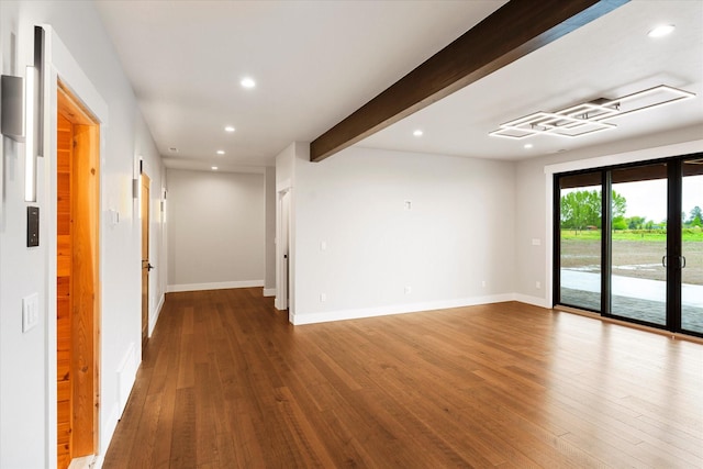 empty room featuring beam ceiling, recessed lighting, and wood finished floors