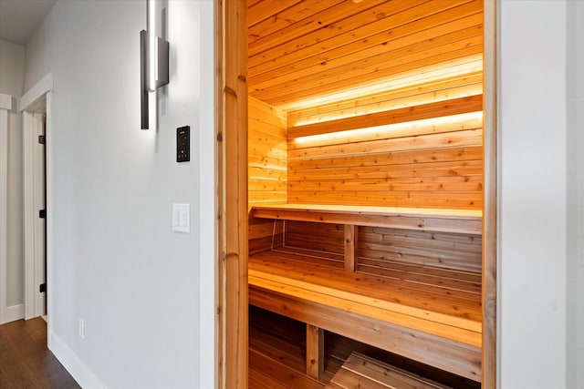 view of sauna / steam room featuring baseboards and wood finished floors