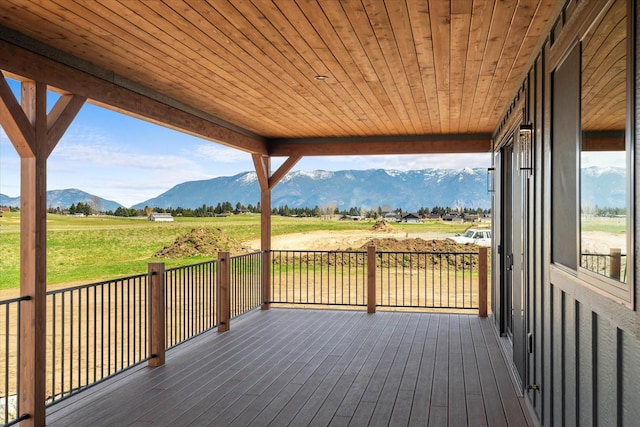 deck with a rural view and a mountain view