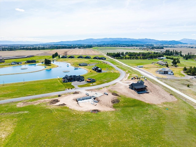 drone / aerial view with a rural view and a water and mountain view