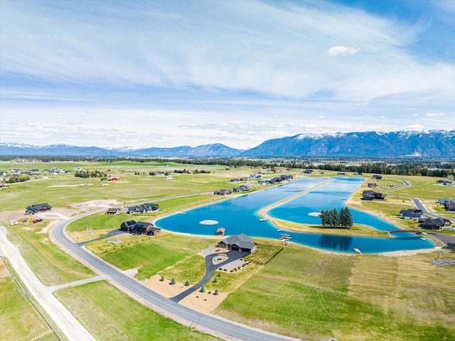 drone / aerial view with a water and mountain view