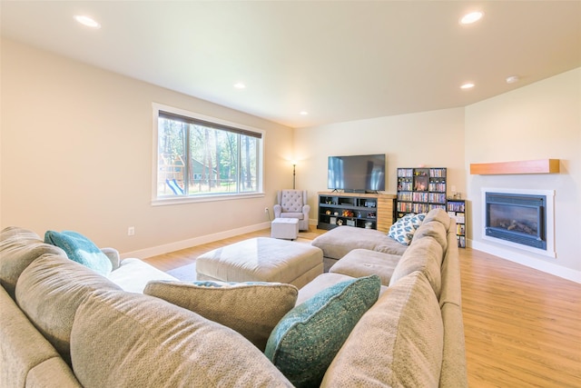 living room featuring recessed lighting, light wood-type flooring, and baseboards