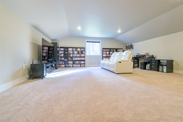 living area featuring baseboards, lofted ceiling, and carpet floors