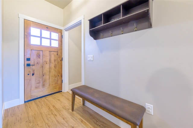 mudroom featuring baseboards and light wood-style floors