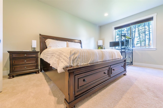 bedroom with light carpet, recessed lighting, and baseboards