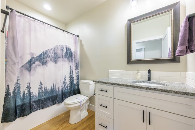 full bath featuring toilet, vanity, and wood finished floors