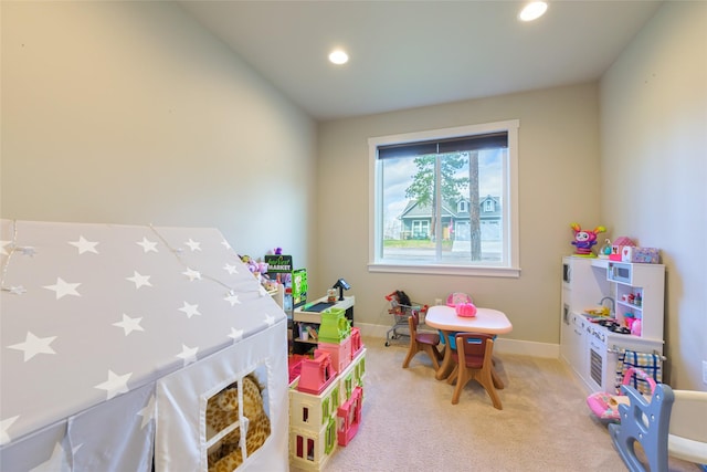 rec room featuring recessed lighting, light colored carpet, and baseboards