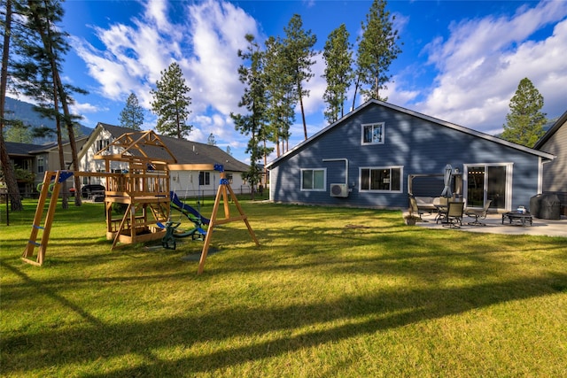 rear view of house with a playground, fence, a patio area, and a lawn