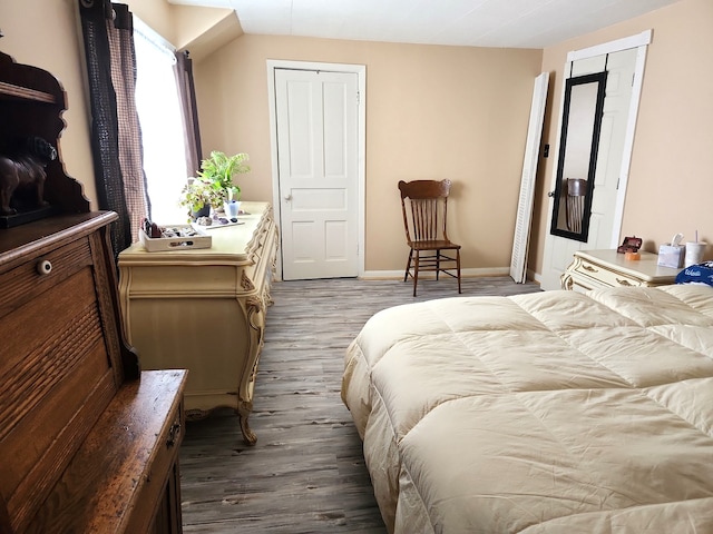 bedroom with baseboards and wood finished floors