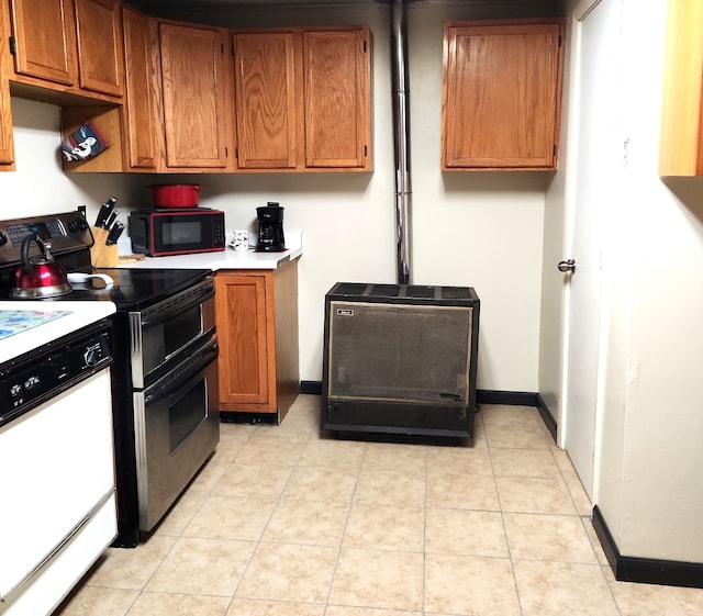 kitchen featuring brown cabinets, dishwasher, black microwave, and range with two ovens