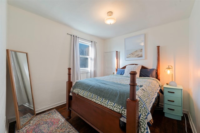 bedroom with baseboards and wood finished floors