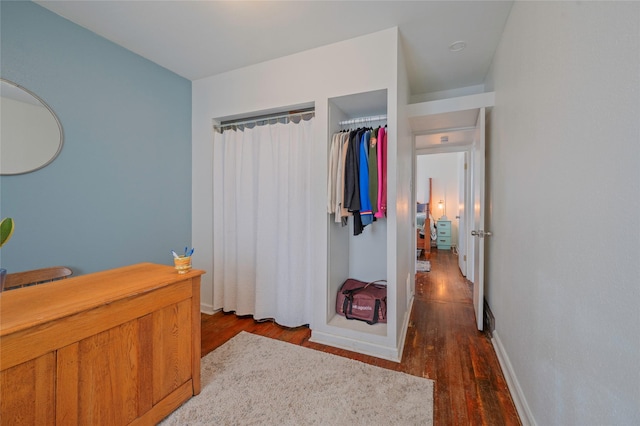 bedroom featuring baseboards and wood finished floors