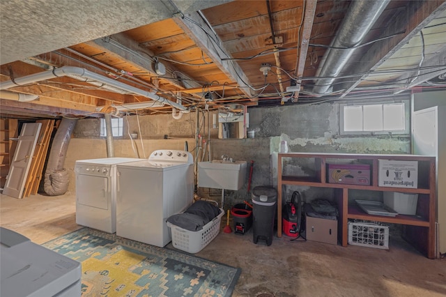 below grade area featuring a sink, fridge, and separate washer and dryer