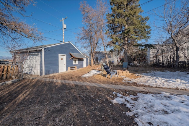 exterior space with a detached garage, driveway, and an outdoor structure