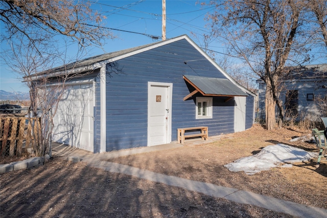 exterior space with an outbuilding and fence