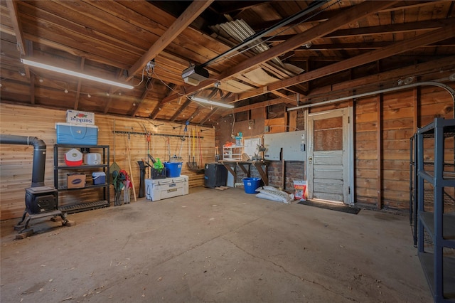 garage with a wood stove and a garage door opener