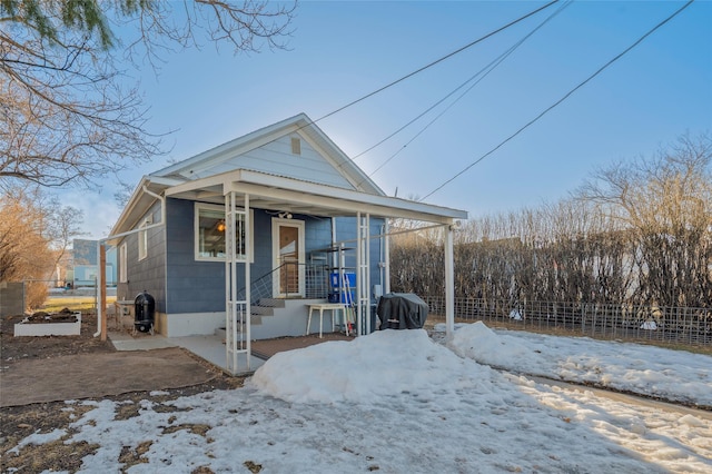 shotgun-style home featuring fence