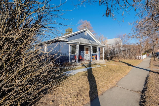 view of front of property with a front lawn and fence