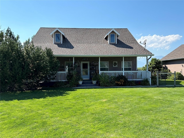 view of front of property with covered porch, a front yard, and roof with shingles