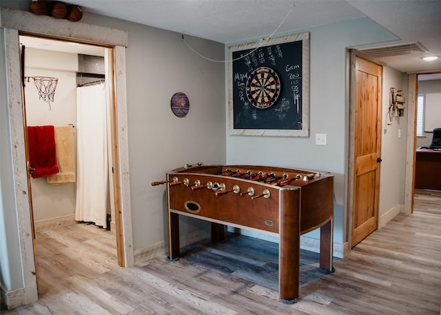 game room featuring baseboards and wood finished floors