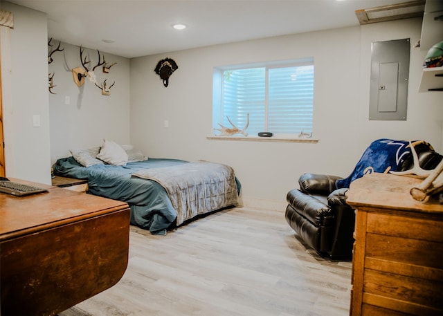 bedroom featuring attic access, electric panel, recessed lighting, and light wood finished floors