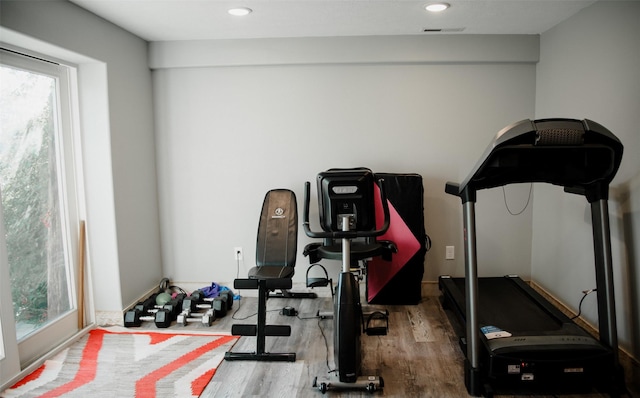 exercise room with recessed lighting, visible vents, and wood finished floors