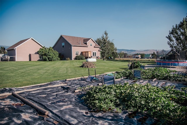 view of yard featuring a mountain view and a trampoline