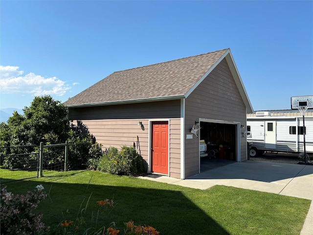 detached garage featuring fence