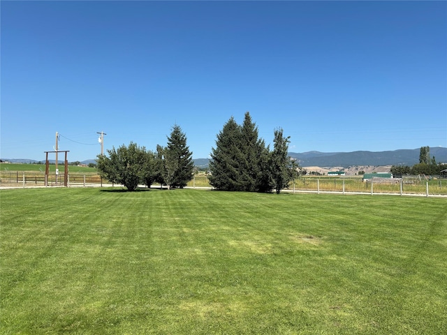 view of yard with a mountain view, a rural view, and fence