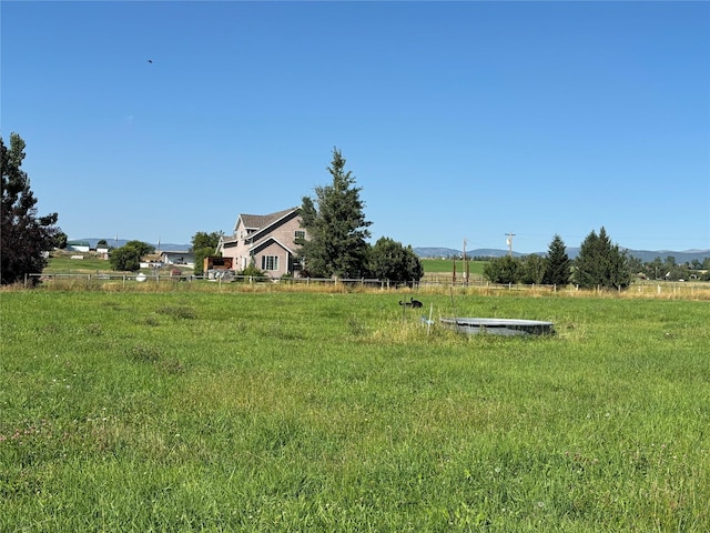 view of yard with a rural view