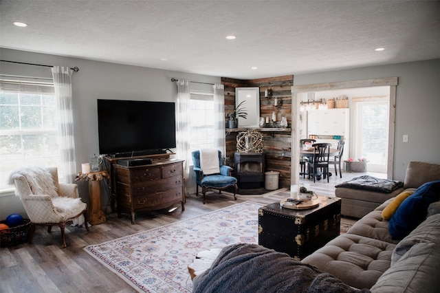 4735 Drake Ln, Stevensville, MT 59870 - living room featuring a wood stove, recessed lighting, wood finished floors, and a textured ceiling