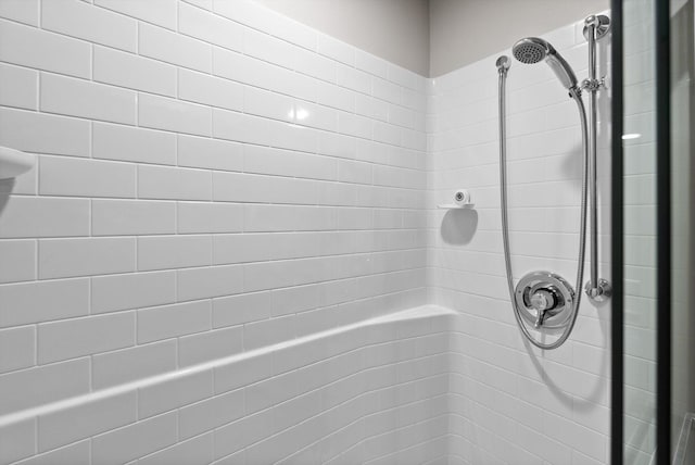 bathroom with a tile shower