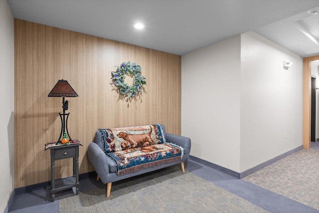 living area with baseboards and carpet floors