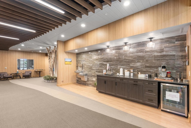 bar featuring wine cooler, recessed lighting, indoor wet bar, and a sink