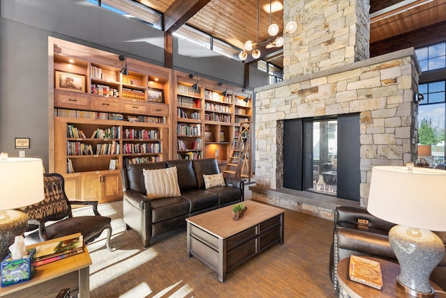 living room featuring wooden ceiling, a fireplace, and beam ceiling