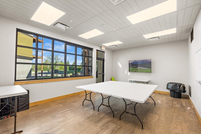 office area with a drop ceiling, baseboards, and wood finished floors