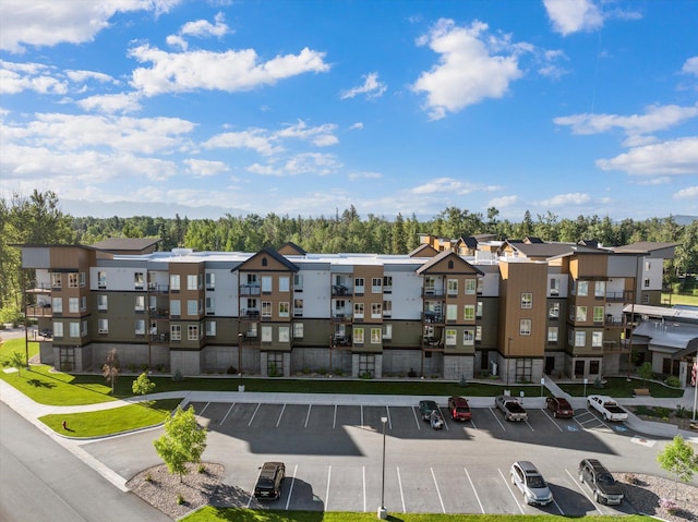 view of building exterior featuring a residential view and uncovered parking